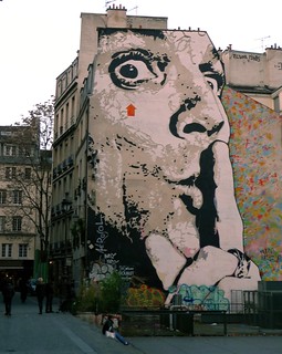 Mural of a man covering his mouth with one finger