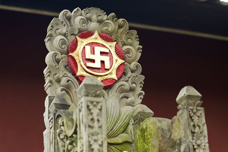 Decorative stone throne with a red and gold swastika