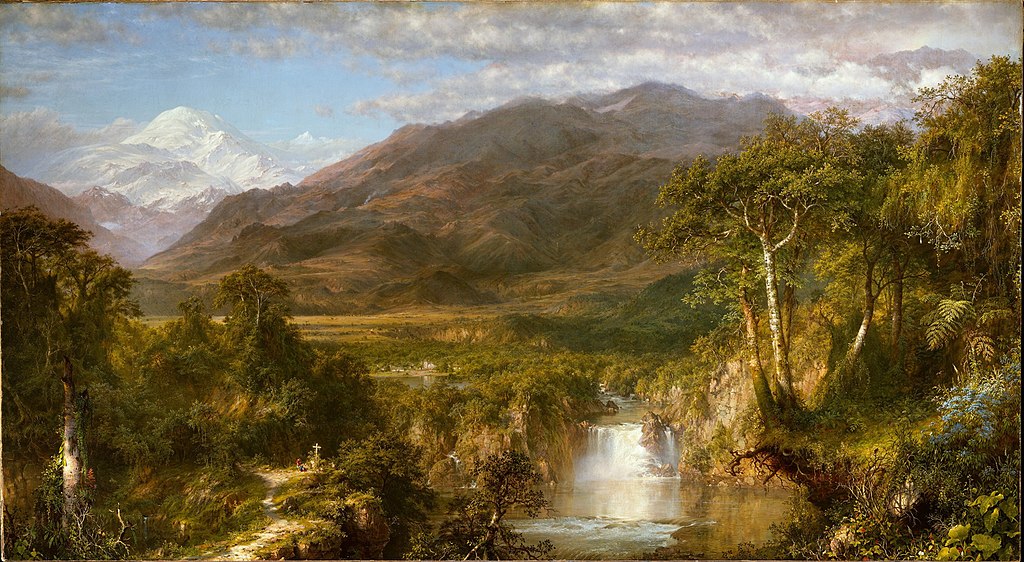 Small waterfall in the middle of a jungle with mountains behind