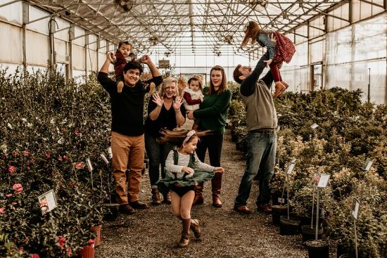 Family posing for photo in a greenhouse.jpg