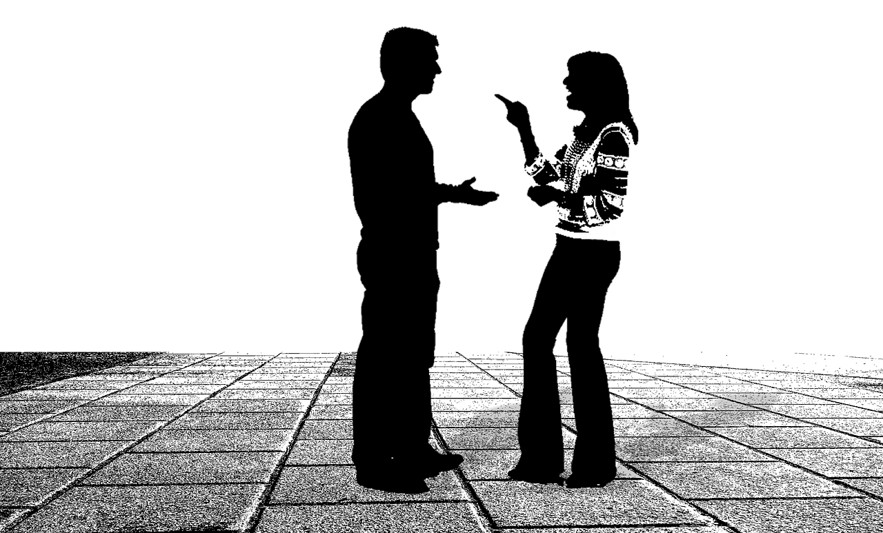 Silhouettes of two people arguing
