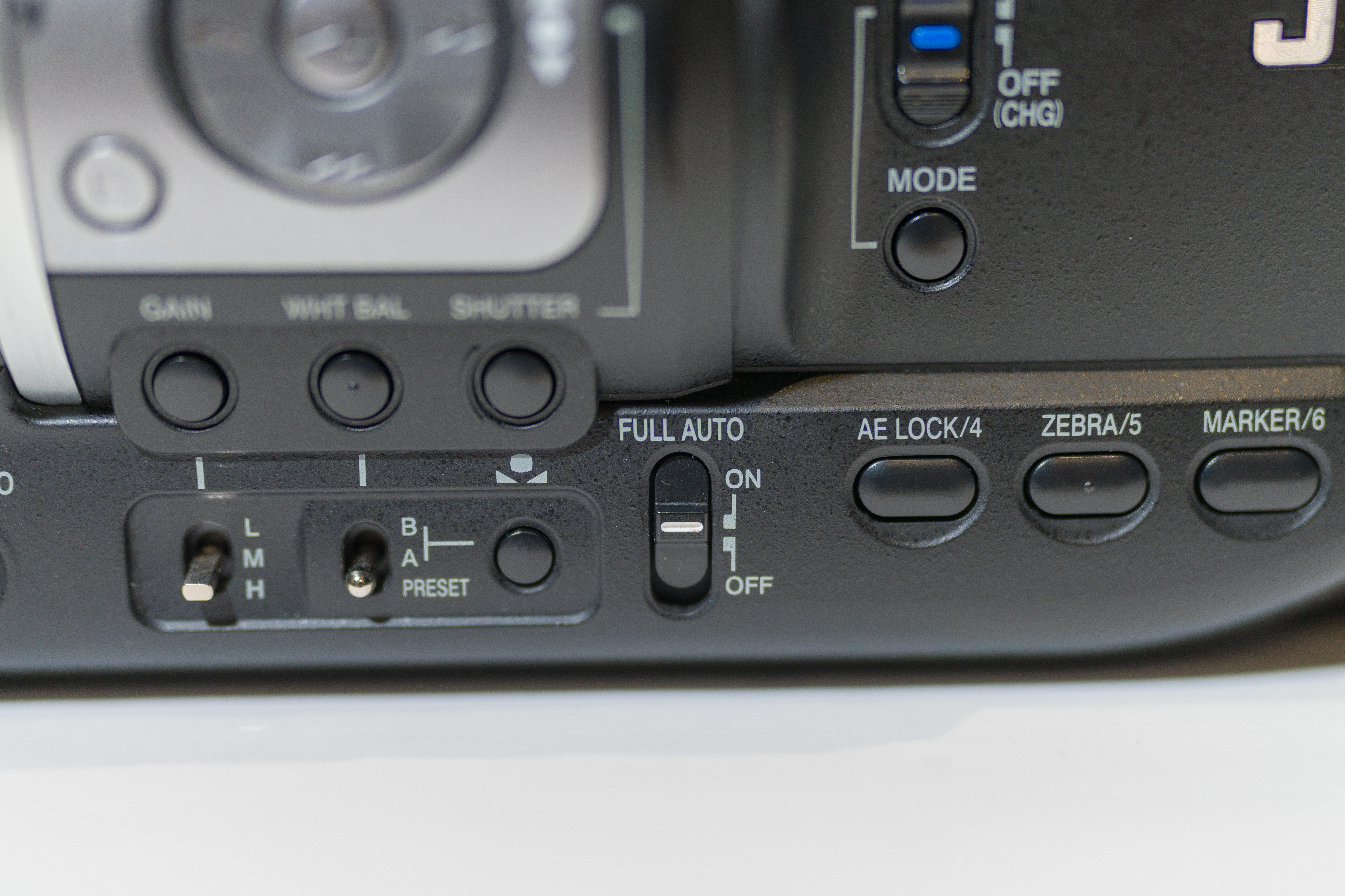 Full auto switch on a video camera set to on. 