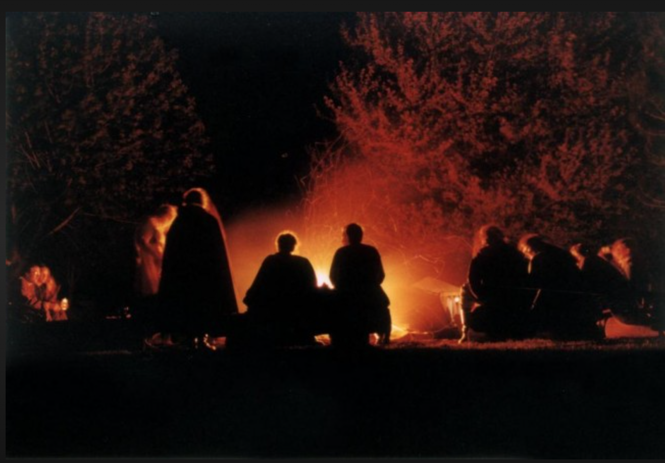 people sitting around a fire