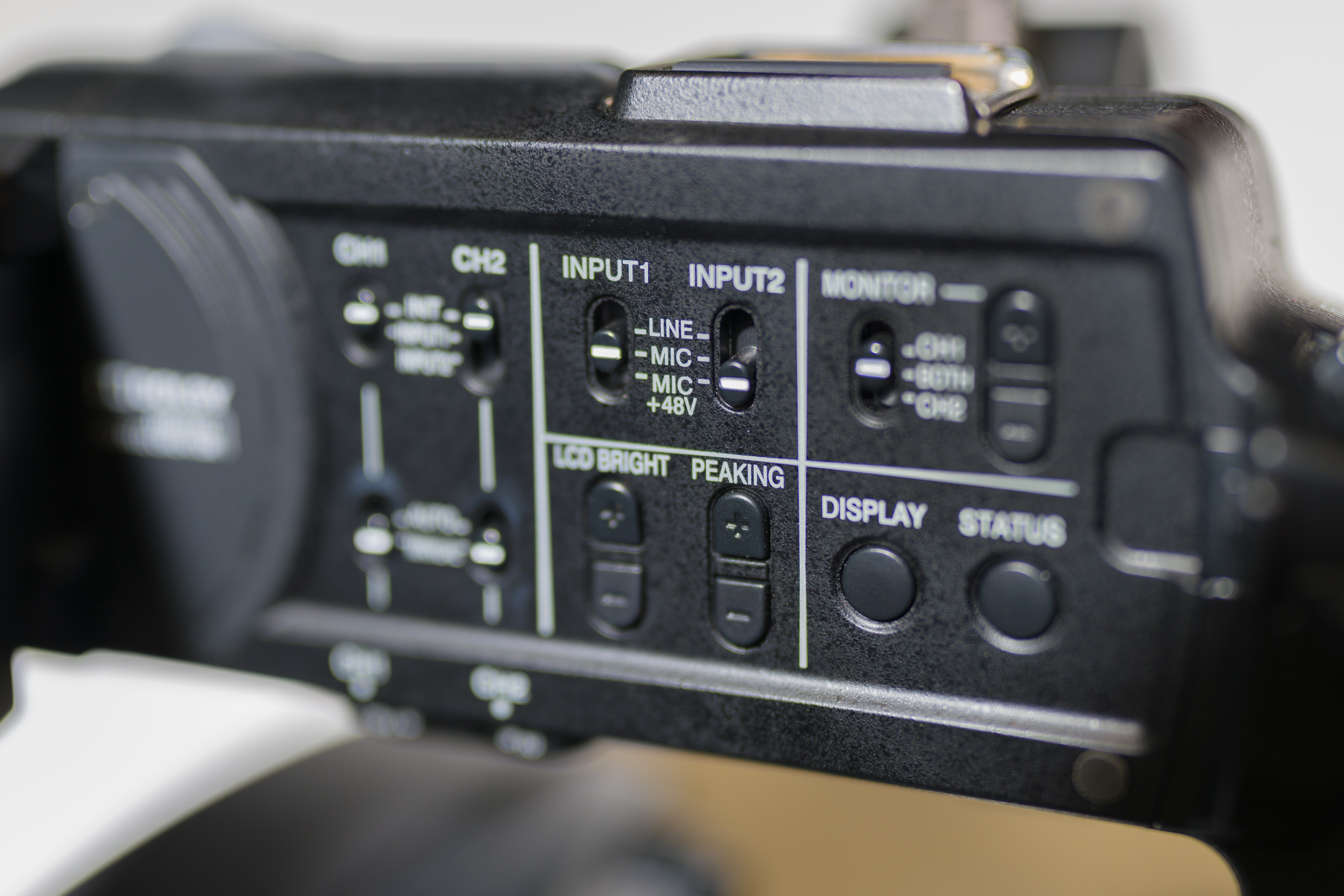 Side of video camera showing input controls for two inputs that can be set to Line, Mic, and Mic +48v. 