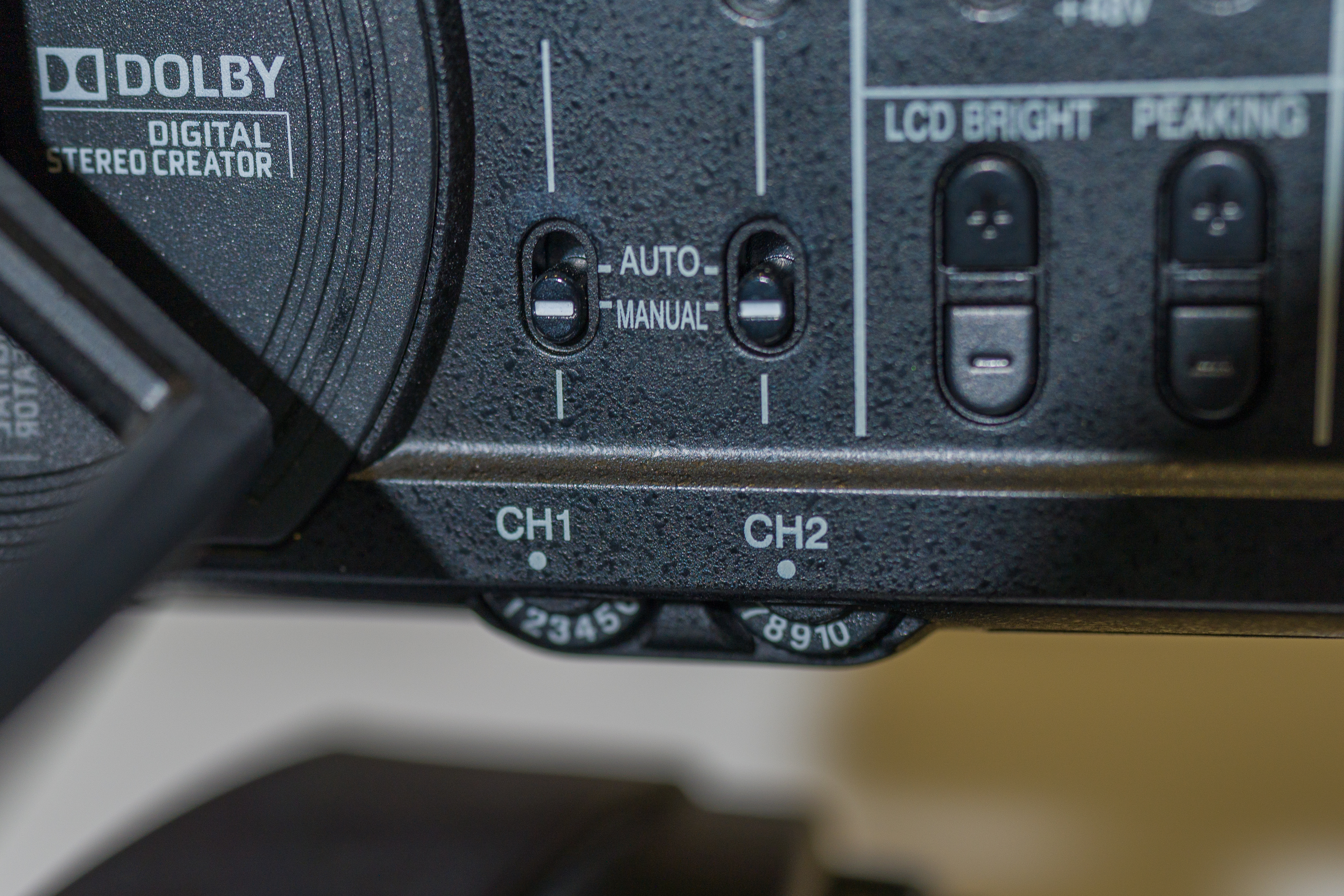 Video camera manual/auto volume switch and two volume dials when manually controlling audio.