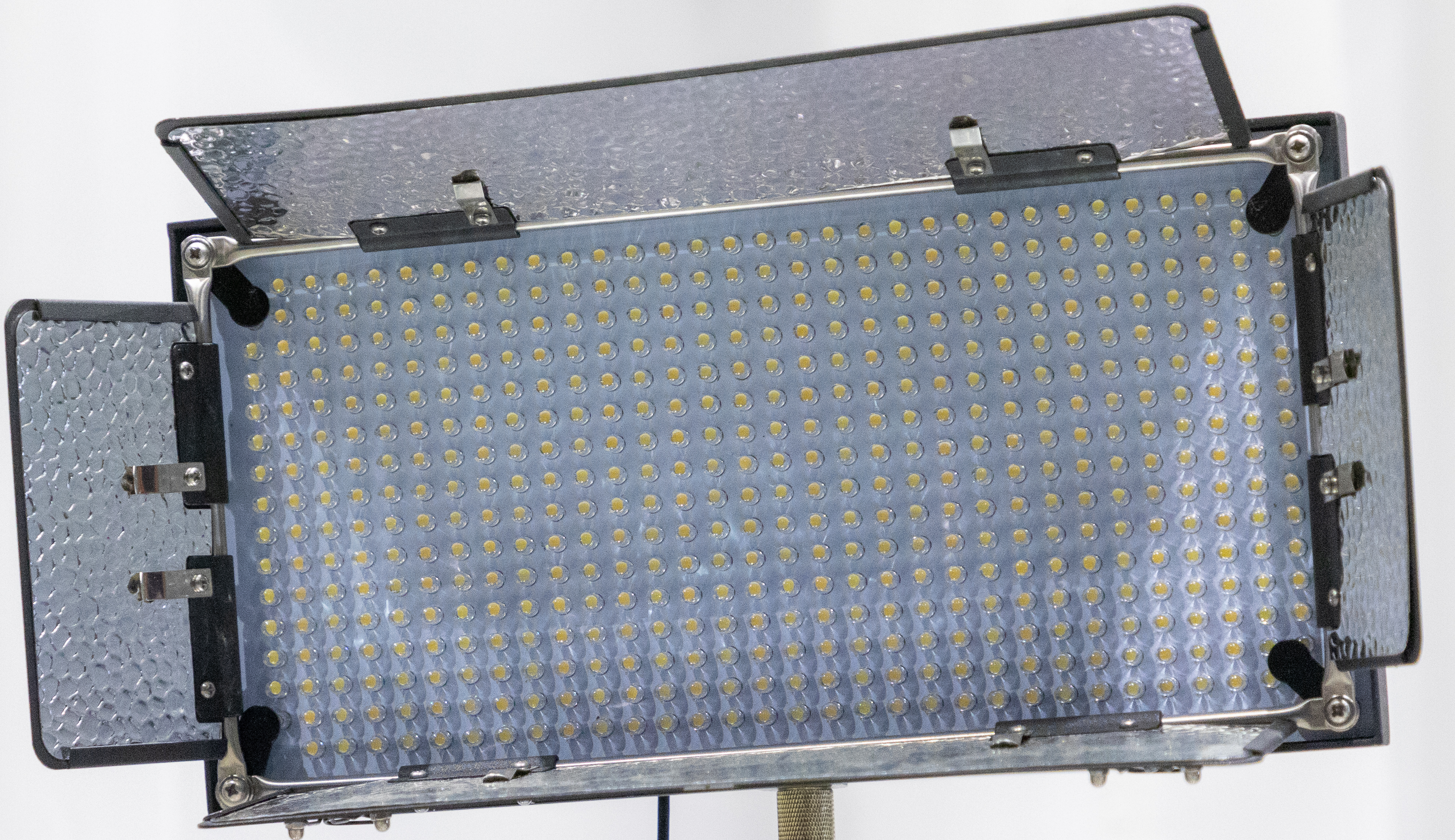 A rectangular panel light with many tiny light bulbs that are LEDS. 