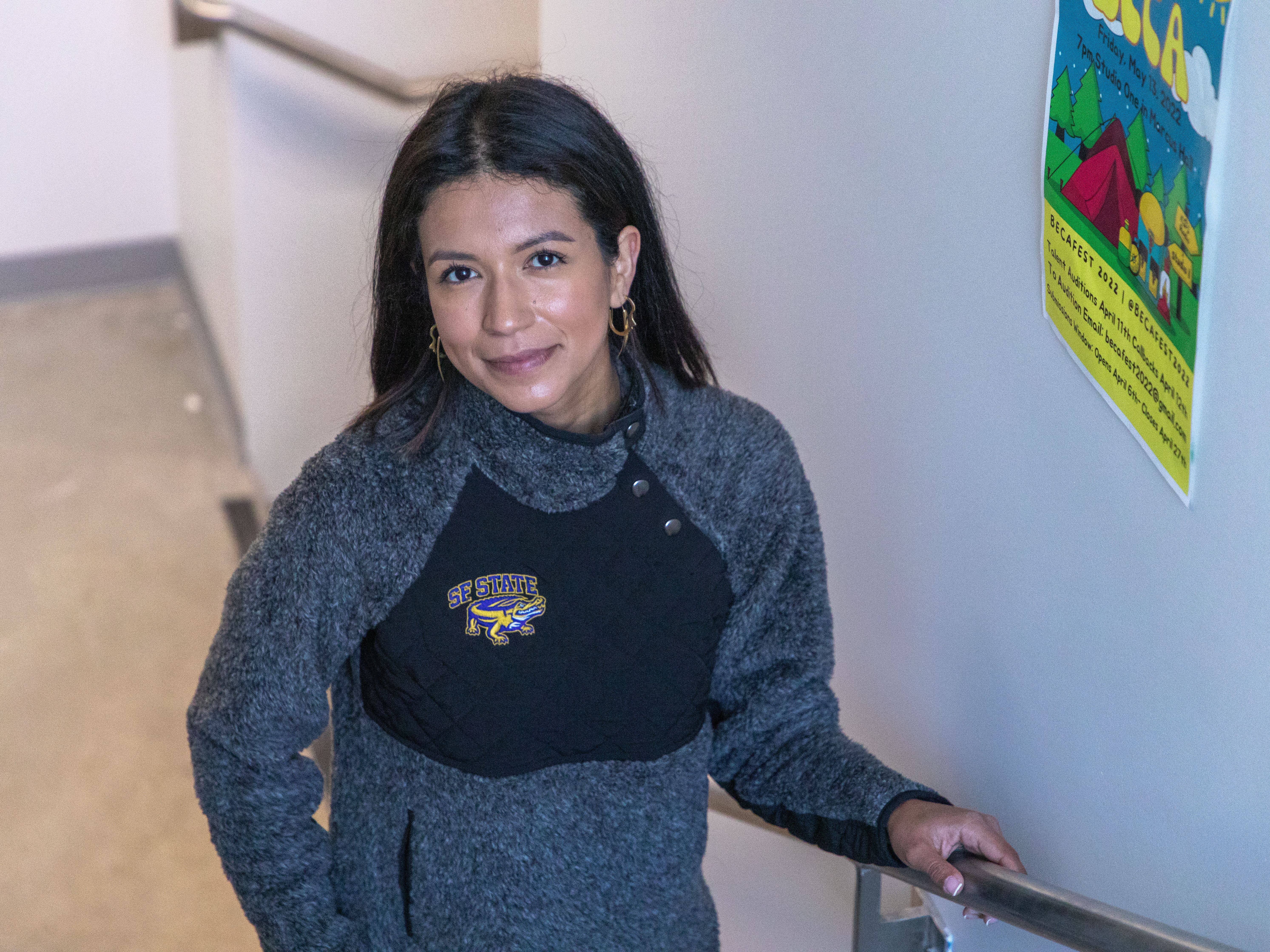 A women on stairs. We are on a higher step looking down at her.