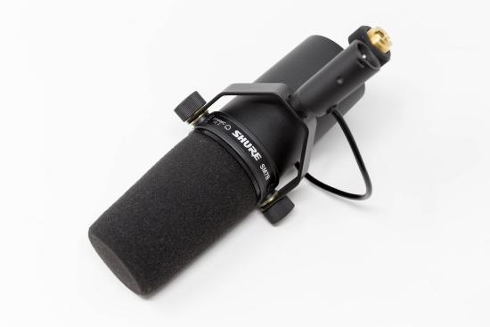 Example of dynamic microphone: Black cylindrical shape with sound foam at the top.