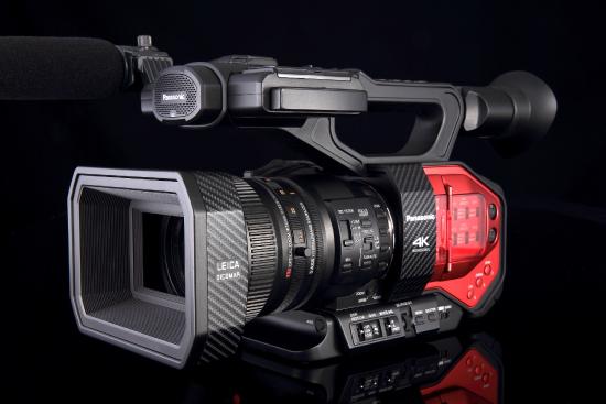 A diagonal side view of a camcorder with control buttons on the side and a handle on top.