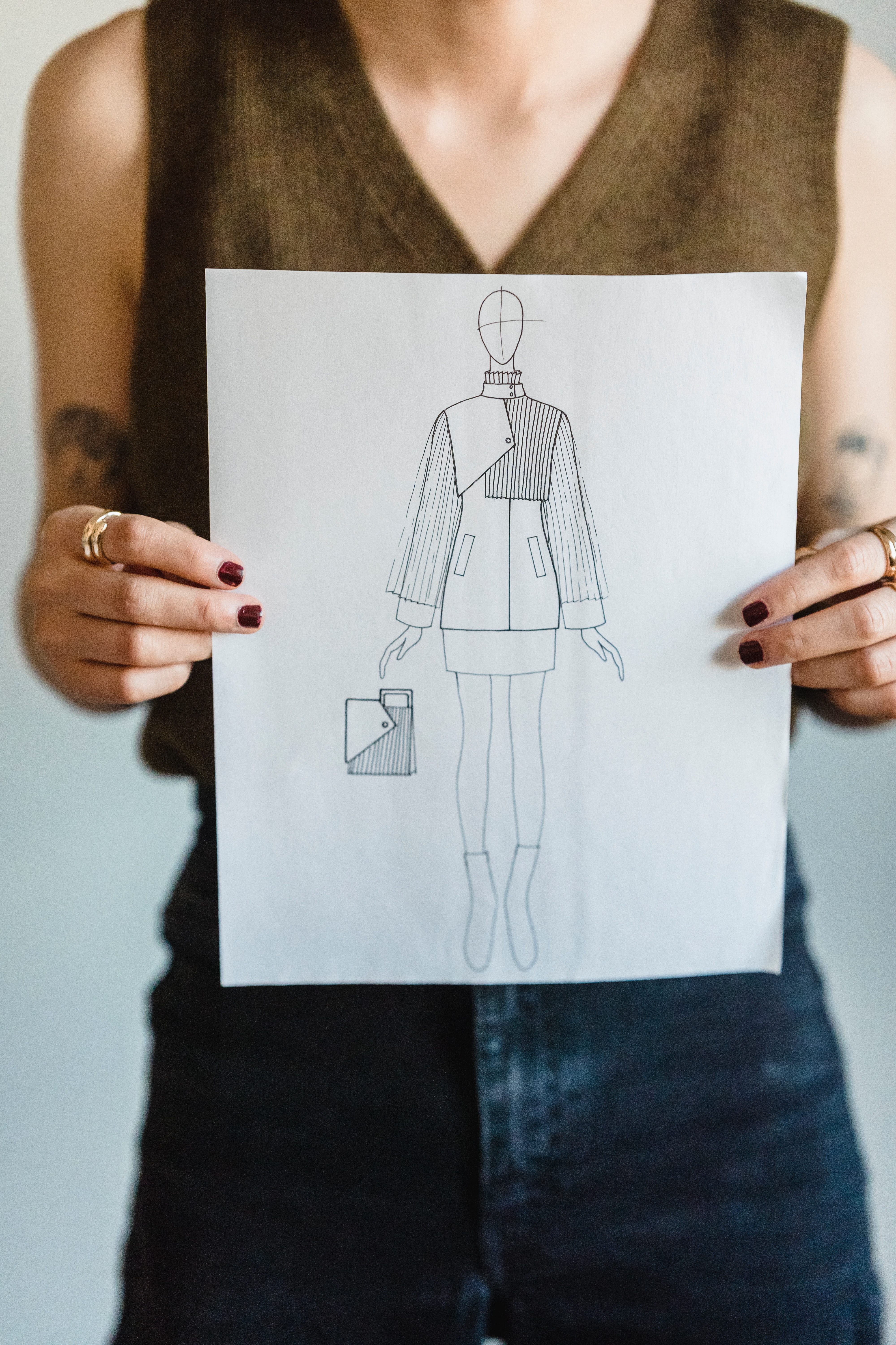 A rough sketch without color of an asymmetric jacket on a mannequin. 