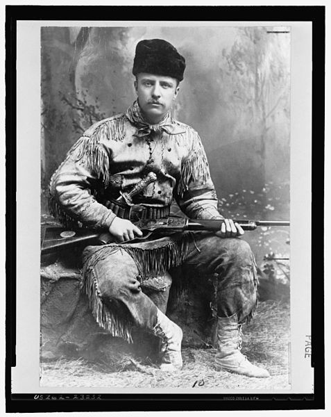 477px-Theodore_Roosevelt_with_hunting_suit_and_rifle_3a24199u_original.jpg