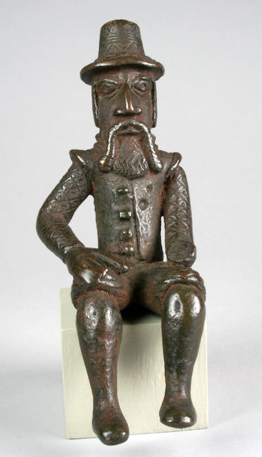 Figure: Seated Portuguese Male, 18th century, Nigeria, Court of Nebnin, Edo peoples, brass, 12.7 x 5.1 x 6 cm (The Metropolitan Museum of Art)