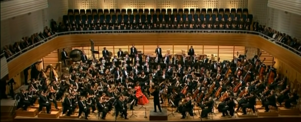 A large orchestra performs Mahler's 3rd symphony. Much larger than the previous eras' orchestra size