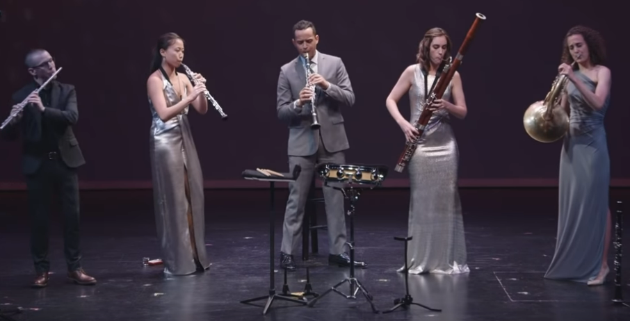 Members of a woodwing quintet including a bassoon, oboe, French horn, clarinet, and flute player