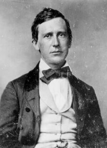 Black and white image of Stephen Foster wearing a suit and bow tie.