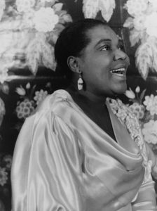 Black and white image of Bessie Smith in a silky top.