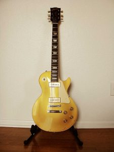 Photograph of yellow electric guitar.