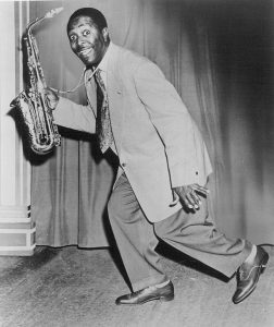 Louis Jordan holding an alto saxophone.