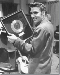 Elvis Presley with award.