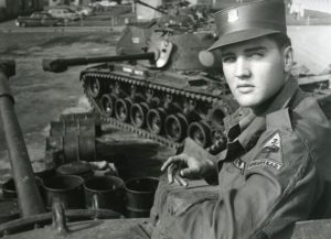 Image of Elvis near a tank.