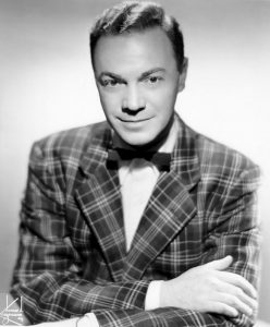 Photographic image of Alan Freed wearing plaid jacket and a bow tie.