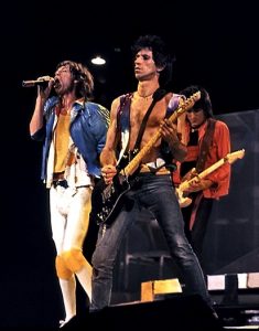 Color image of the Rolling Stones performing live.