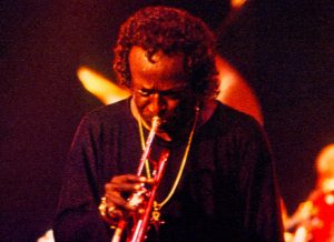 Color photo of Miles Davis playing the trumpet