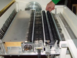 Color photo of a person changing the tape cartridge on a mellotron.