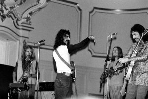Black and white photo of Frank Zappa and band performing live