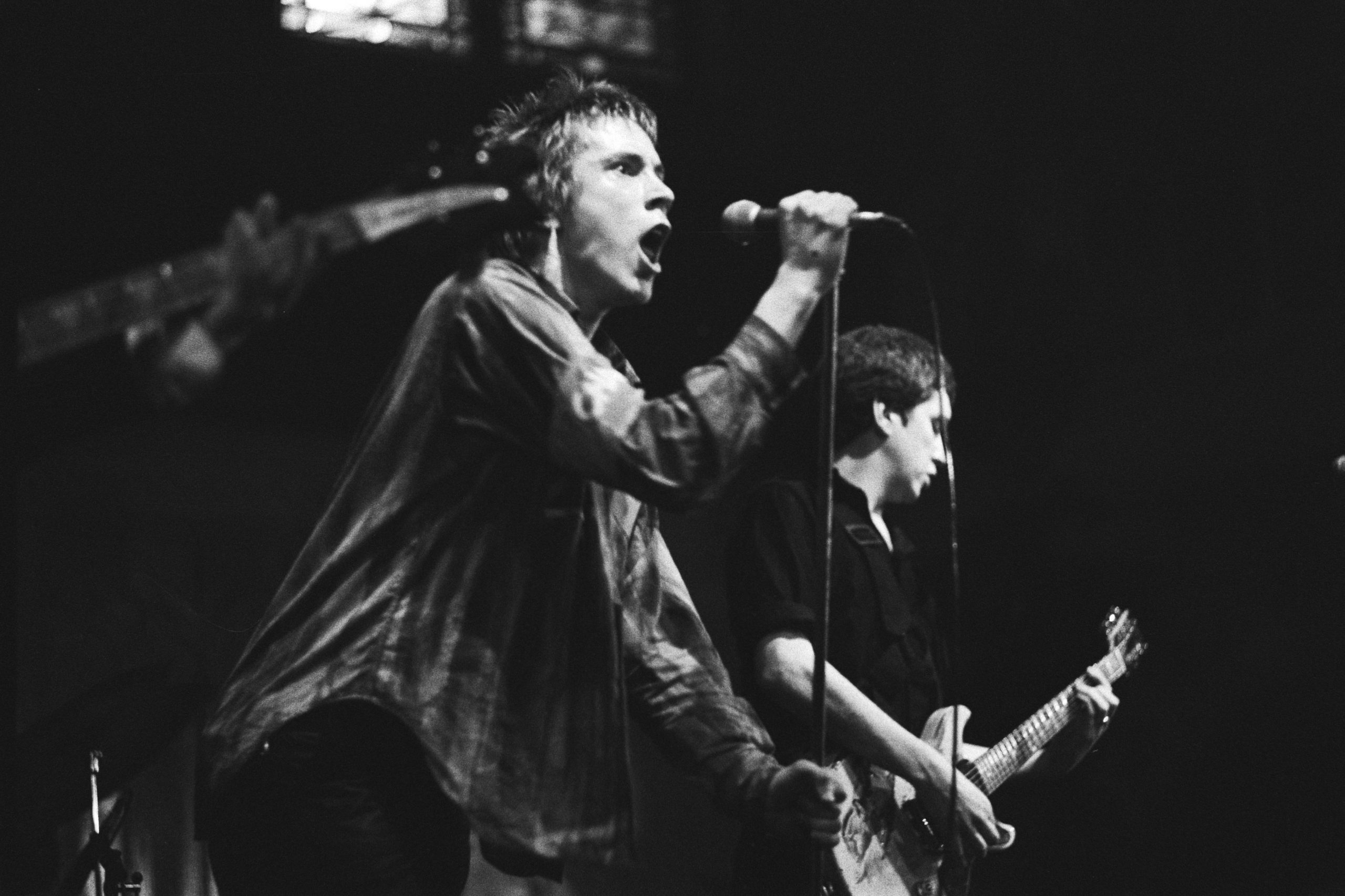 Black and white photo of the lead singer of The Sex Pistols performing live