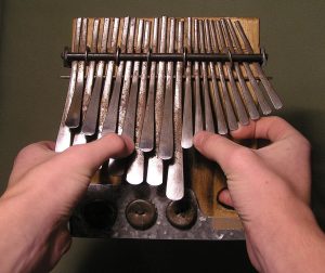 Small metal instrument that is played with ones thumbs.