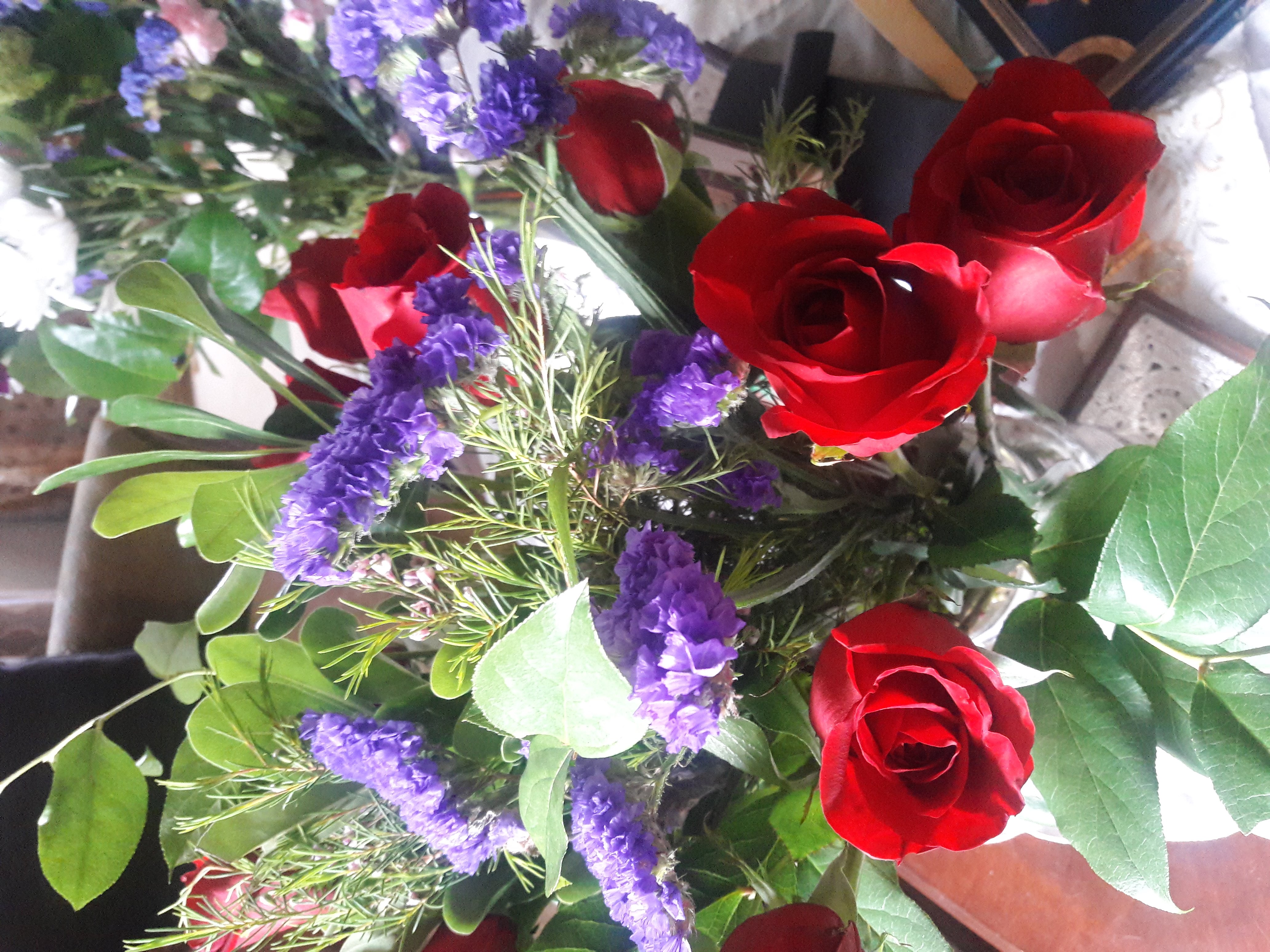 Bouquet of red roses and other purple roses in a vase. 