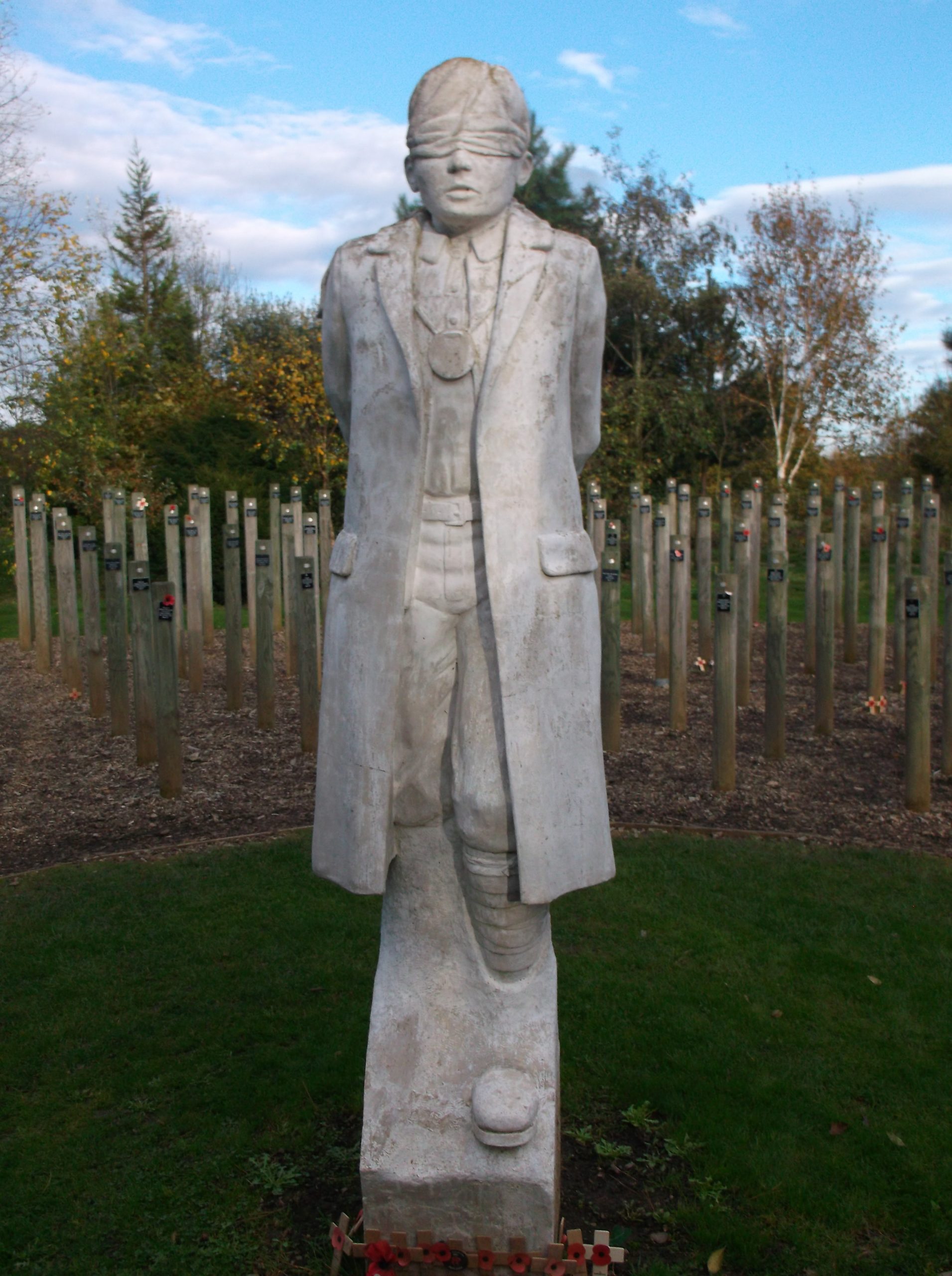 A large white statue of a man wearing a blindfold